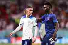Bukayo Saka of England celebrates with Phil Foden after the FIFA World Cup Qatar 2022 Group B match between Wales and England at Ahmad Bin Ali Stad...