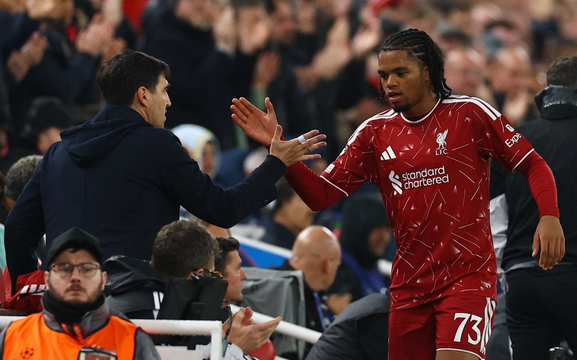 Liverpool manager Andoni Iraola greets Rio Ngumoha