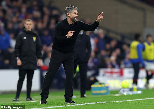 Dons boss Stephen Robinson on the touchline in the 1-0 defeat to Rangers