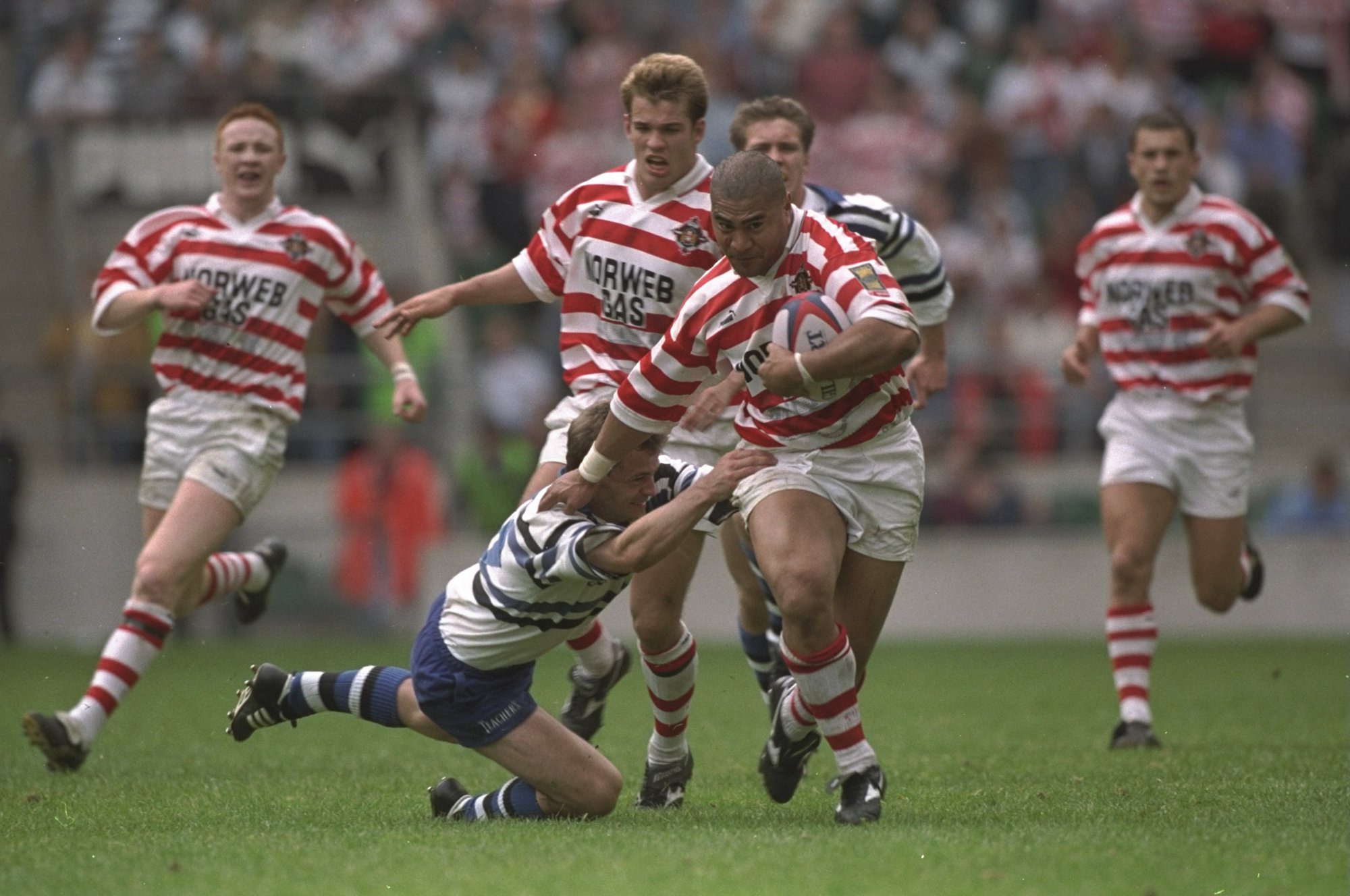 Va'aiga Tuigamala of Wigan runs past a Bath tackle during the rugby union leg of the 1996 Clash of the Codes