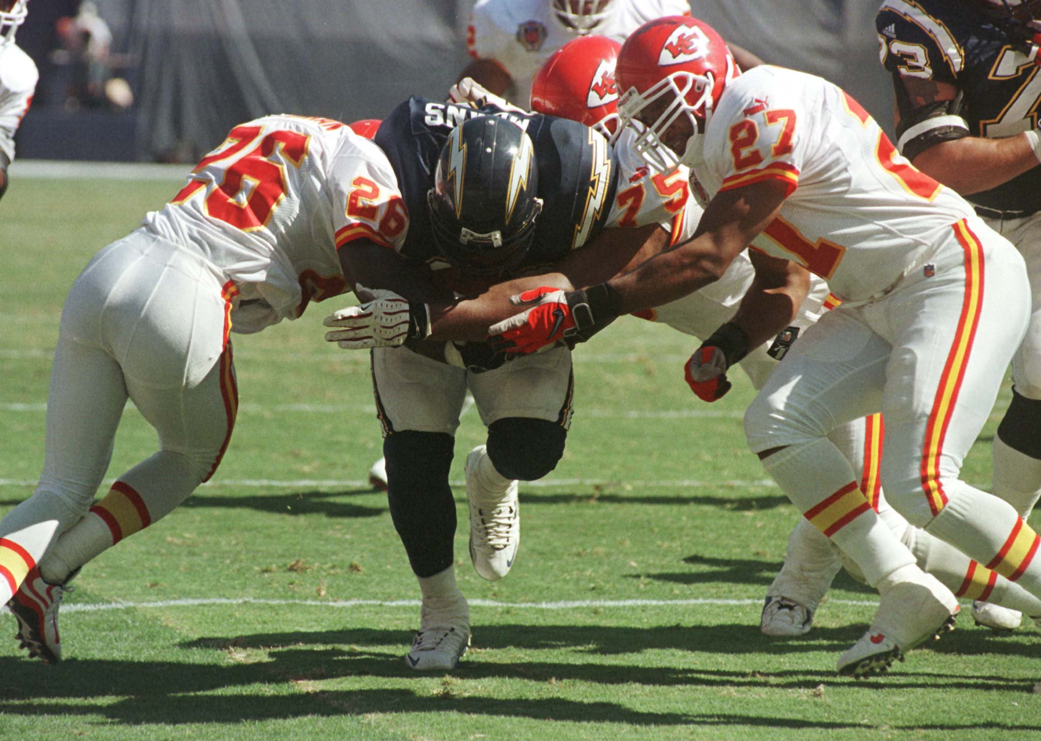 San Diego Chargers running back Natrone Means runs through Kansas City Chiefs defenders Cris Dishman, (26), Bracy Walker, (27) and Chester McGlockton, (75) for a touchdown in the second quarter of the October 3 game in San Diego.

JTL/RC