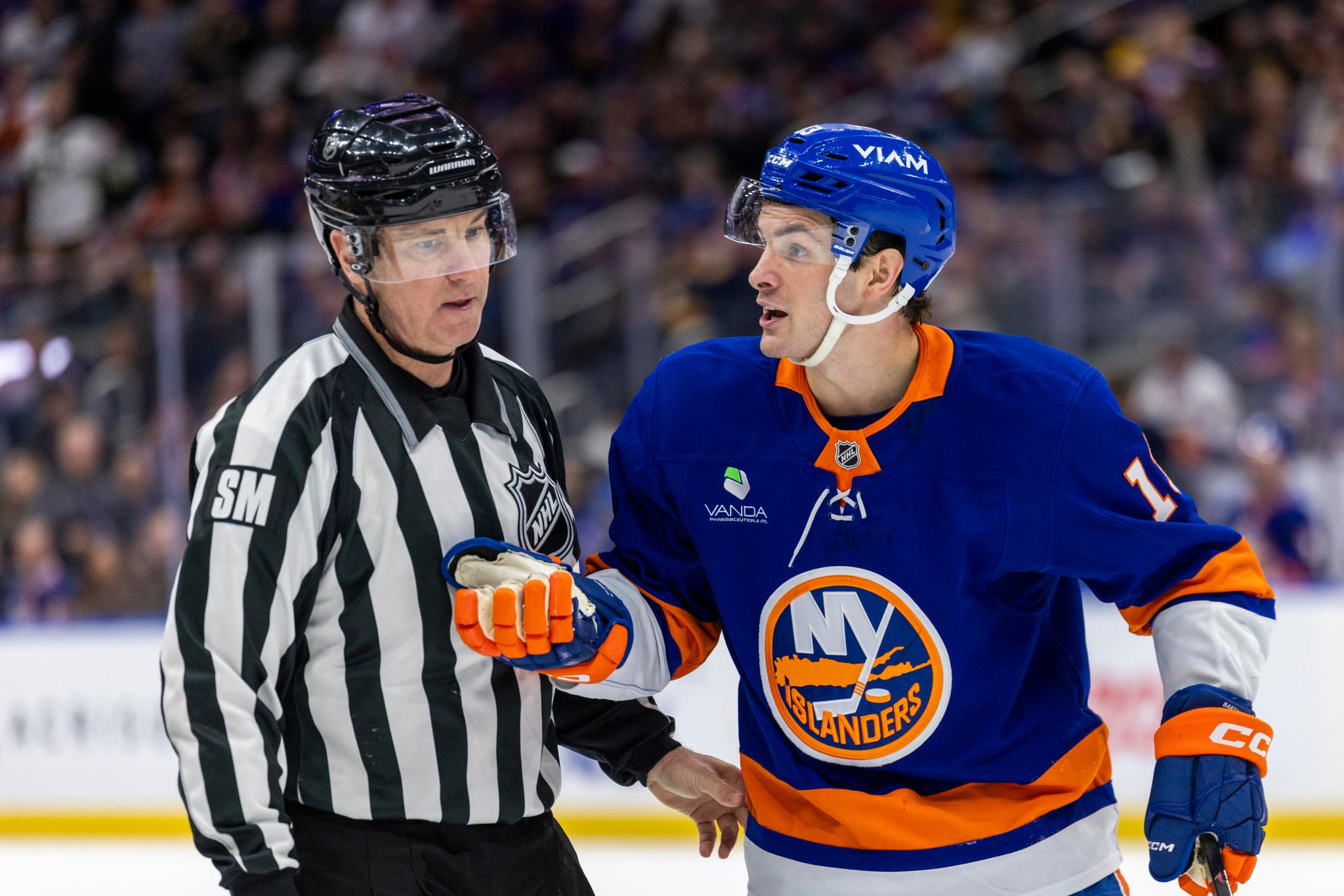 New York Islanders center Mathew Barzal speaks with an official during an NHL game.