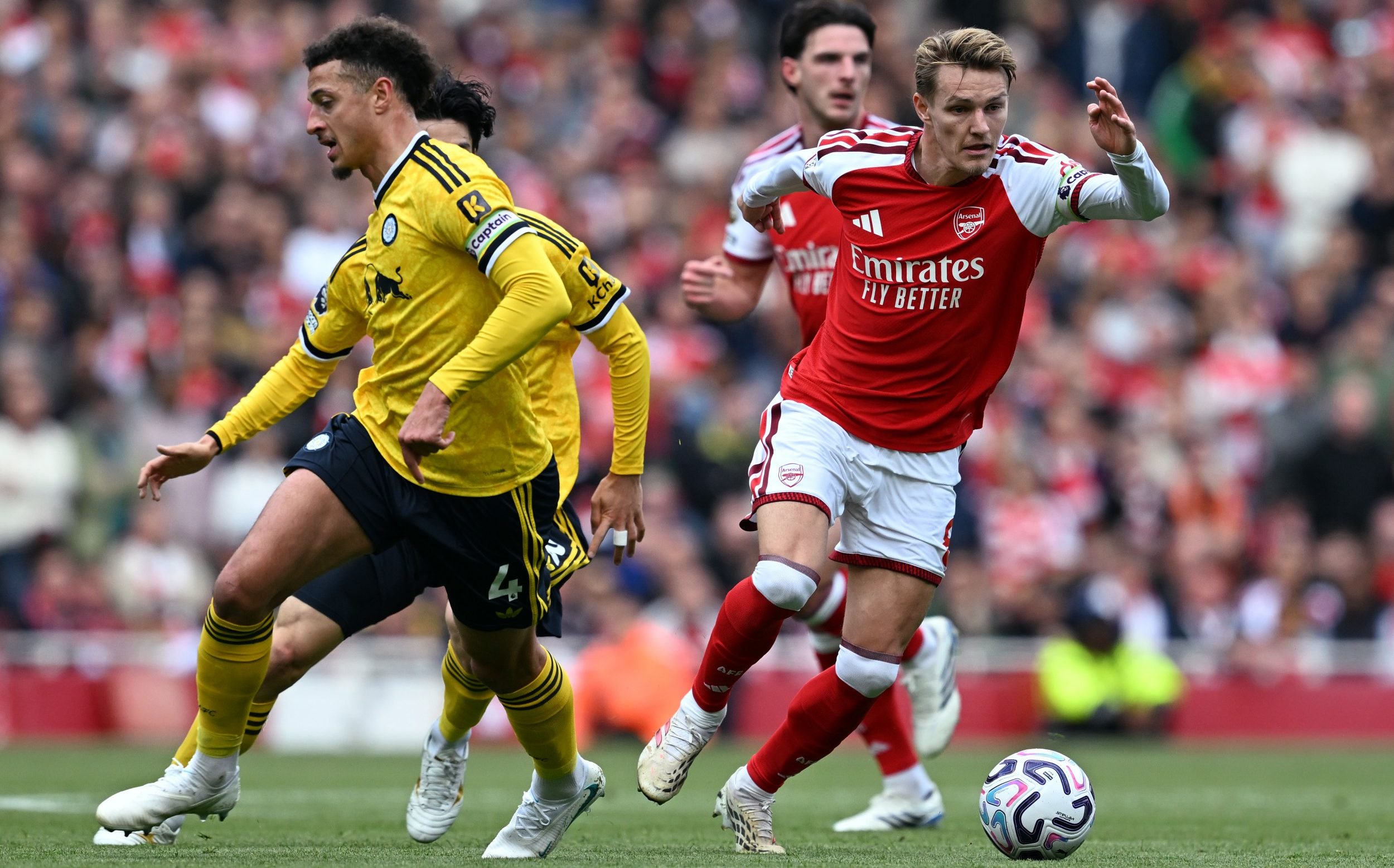 Martin Odegaard drives with the ball against Leeds