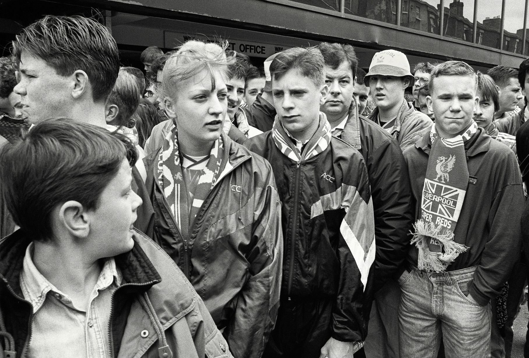 In 1991, photographer Richard Davis followed supporters from across the North West for a book about football, fashion and music. Richard spent much of the season taking pictures of fans from Liverpool, Everton and more for the book Football With Attitude. In collaboration with Lower Block, the Going to the Match zine has been published to coincide with an exhibition of the same name at Bury Art Museum, running from October 2024 to March 2025.
Pictured: Liverpool Fans at Anfield, 1991
