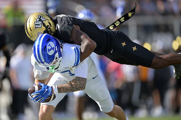 BYU wide receiver Kyler Kasper (3) catches a pass in the end zone for a touchdown as Central Florida defensive back Antione Jackson (7) defends during the first half of an NCAA college football game, Saturday, Oct. 24, 2026, in Orlando, Fla. (AP Photo/Phelan M. Ebenhack)