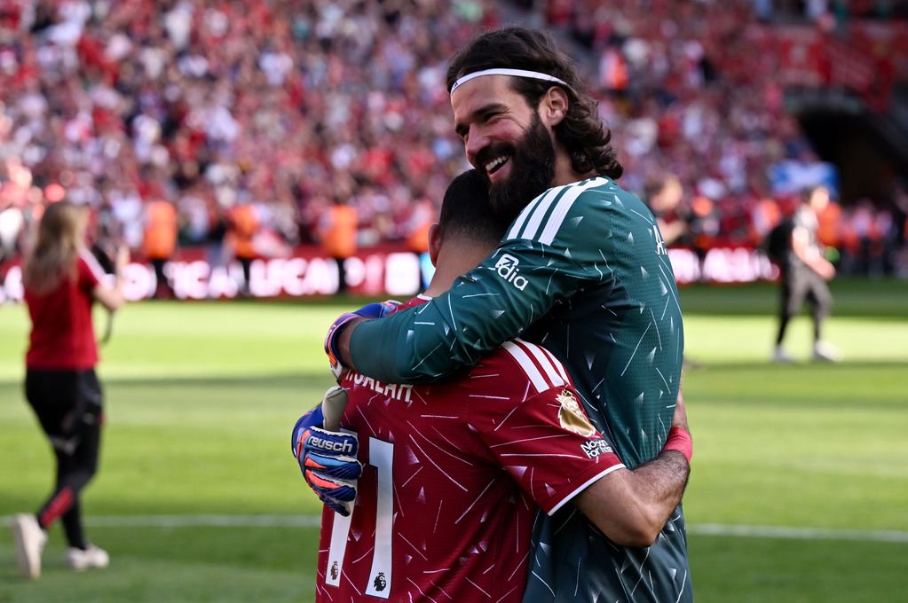Mohamed Salah of Liverpool embraces with teammate Alisson Becker following his final appearance for the club during the Premier League match between Liverpool and Brentford