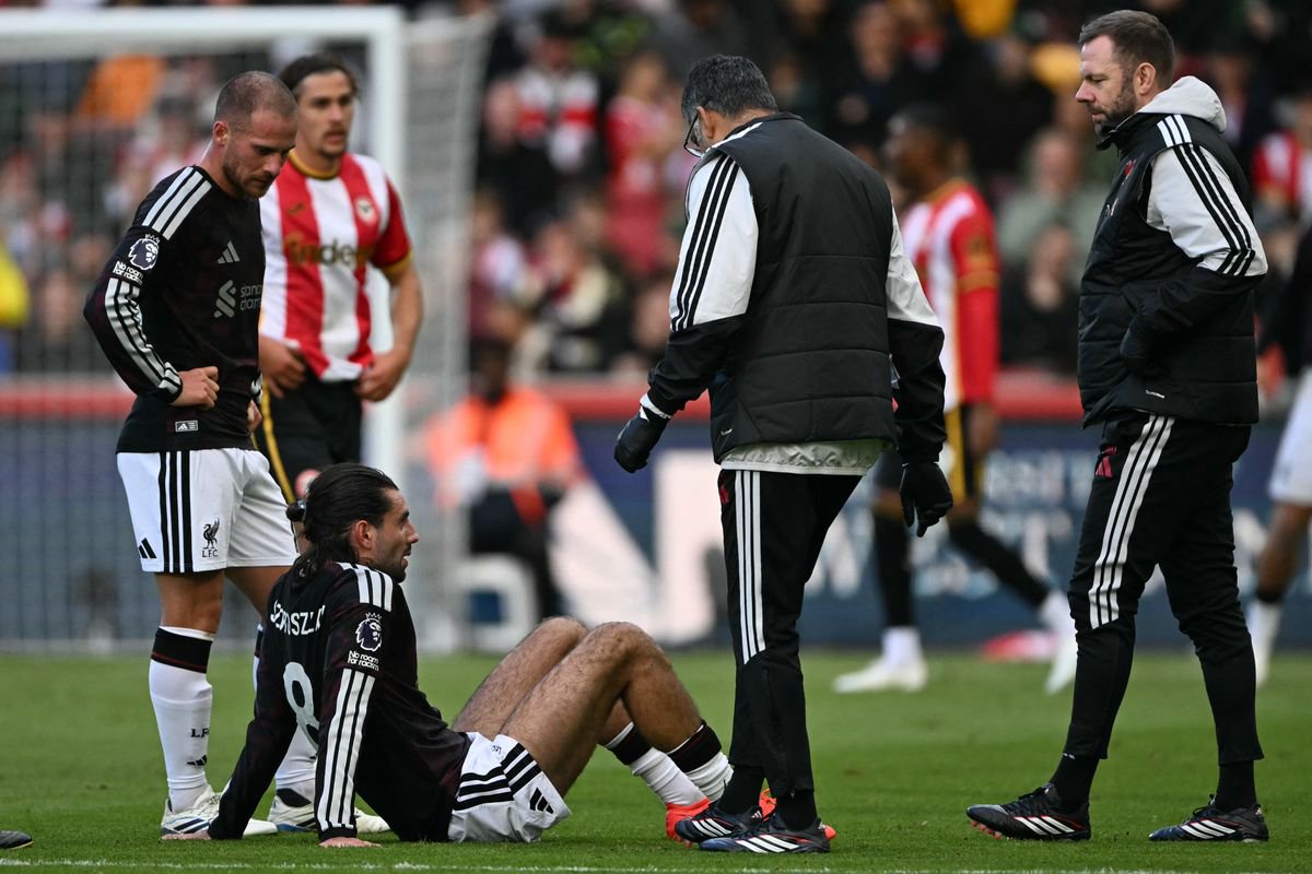 Liverpool's Hungarian midfielder #08 Dominik Szoboszlai (C) reacts after picking up an injury during the English Premier League football match between Brentford and Liverpool at the Gtech Community Stadium in London on October 17, 2026. (Photo by Glyn KIRK / AFP via Getty Images) / RESTRICTED TO EDITORIAL USE. No use with unauthorized audio, video, data, fixture lists, club/league logos or 'live' services. Online in-match use limited to 120 images. An additional 40 images may be used in extra time. No video emulation. Social media in-match use limited to 120 images. An additional 40 images may be used in extra time. No use in betting publications, games or single club/league/player publications.