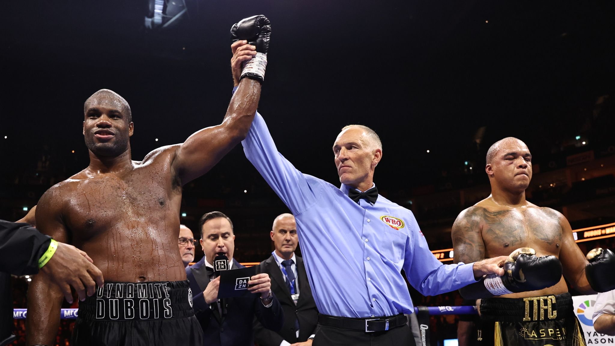 Dubois has his hand raised in victory. (Photos: Leigh Dawney/Queensberry Promotions)