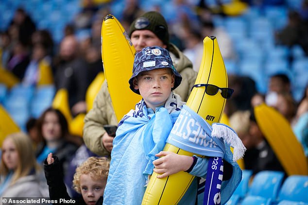 A Manchester City supporter holds an inflatable banana prior to the start of the English Premier League soccer match between Manchester City and Ipswich Town, in Manchester, England, Saturday, Oct.17, 2026. (AP Photo/Dave Thompson)