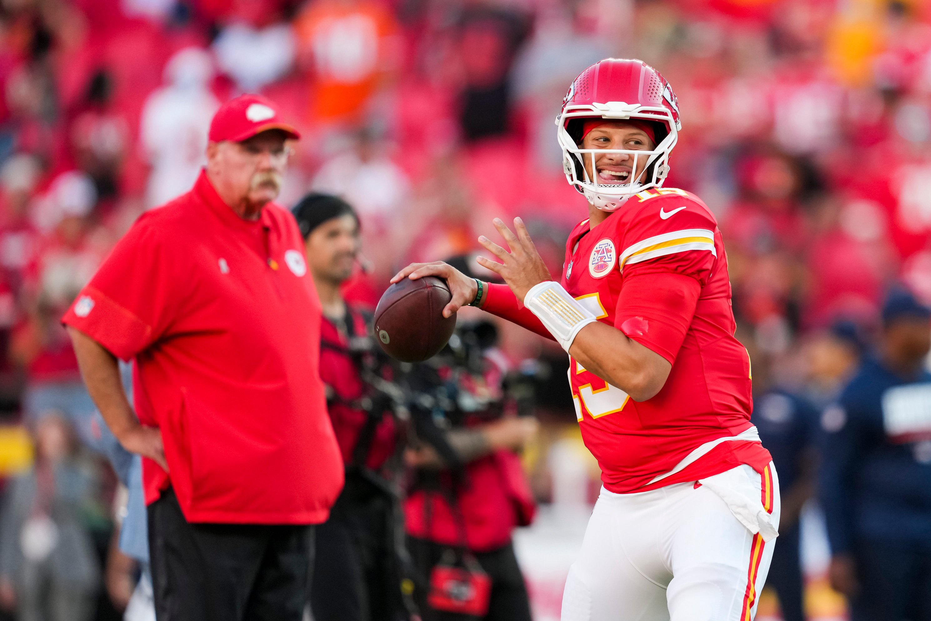 Sep 14, 2026; Kansas City, Missouri, USA; Kansas City Chiefs quarterback Patrick Mahomes (15) warms up as head coach Andy Reid looks on prior to a game against the Denver Broncos at Arrowhead Stadium.