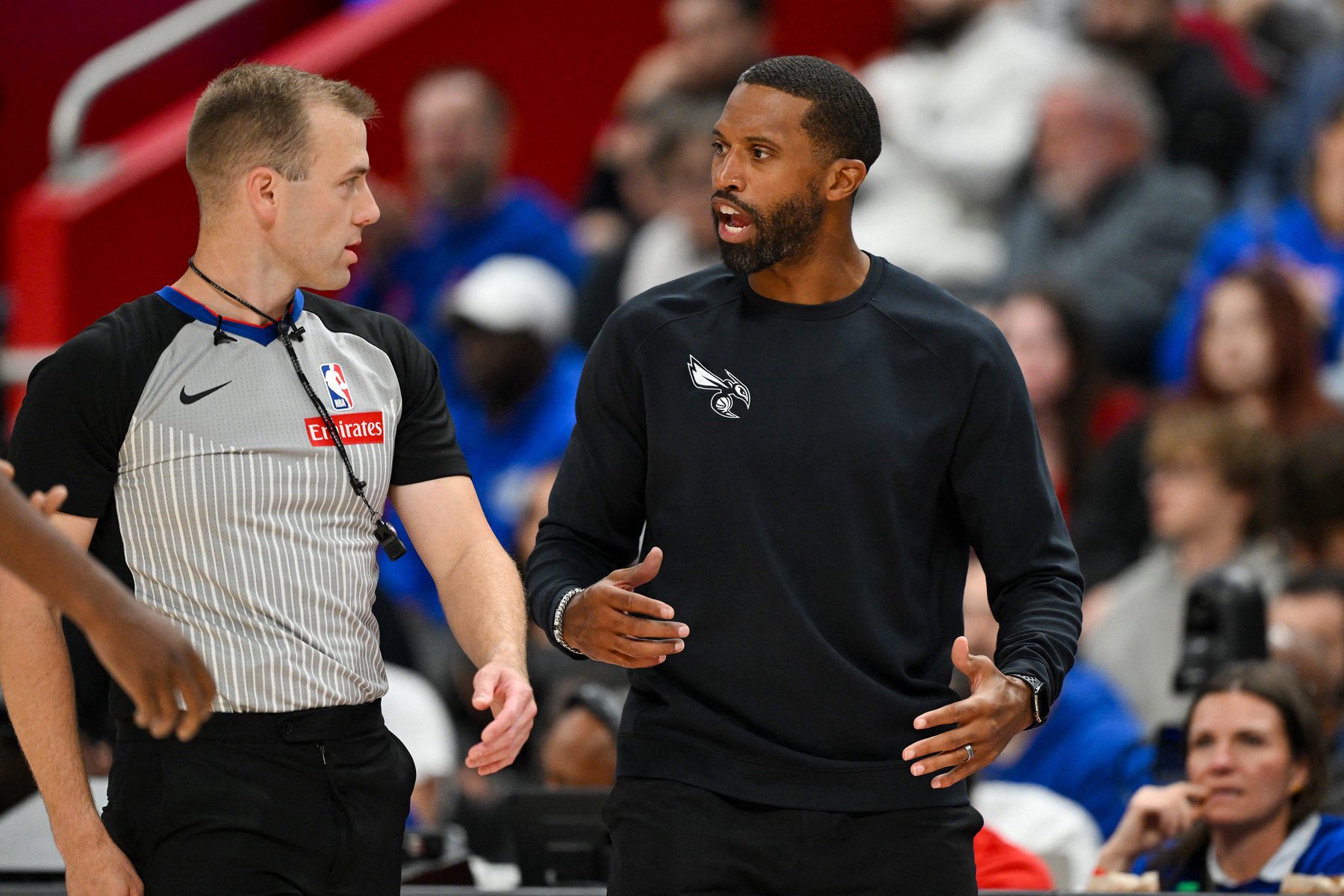 Oct 28, 2026; Detroit, Michigan, USA;  Charlotte Hornets head coach Charles Lee argues with referee Tyler Ricks (95) during their game against the Detroit Pistons in the second half at Little Caesars Arena.  Mandatory Credit: Lon Horwedel-Imagn Images