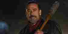 Jeffery Dean Morgan as Negan smiling and holding his bat, Lucille, in The Walking Dead.