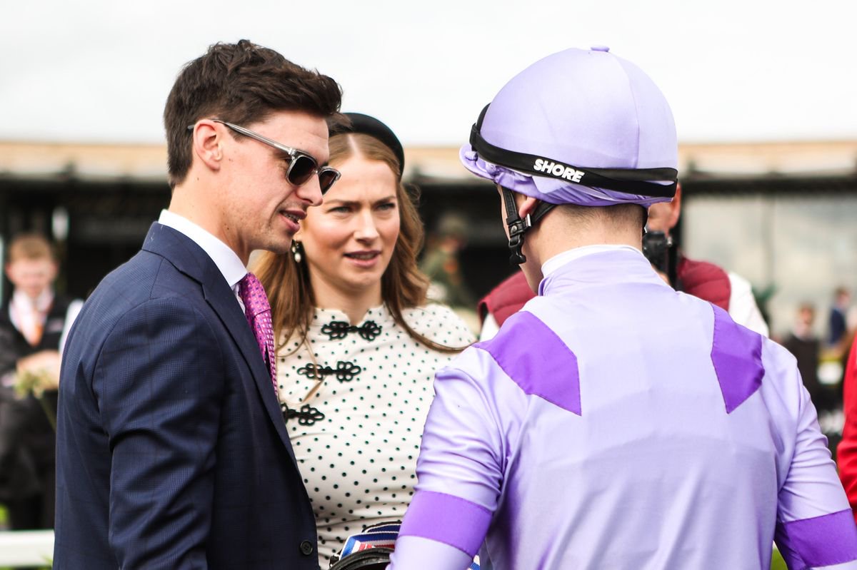 Donnacha O'Brien speaks with jockey Billy Loughnane after his win on Comanche Brave in the BAR 1 Betting Flying Five Stakes 
