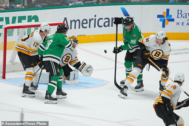 Dallas Stars right wing Mikko Rantanen (96) attacks against Boston Bruins defenseman Nikita Zadorov (91) during the third period of an NHL hockey game Tuesday, Oct. 20, 2026, in Dallas. (AP Photo/Julio Cortez)