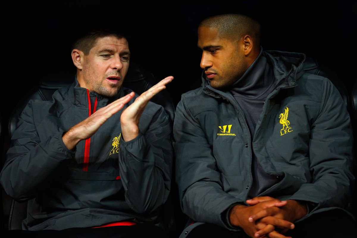Steven Gerrard and Glen Johnson talk as they sit on substitute the bench during the UEFA Champions League Group B match between Real Madrid and Liverpool at Estadio Santiago Bernabeu in November 2014