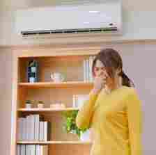 asian woman annoyed at bad indoor air quality