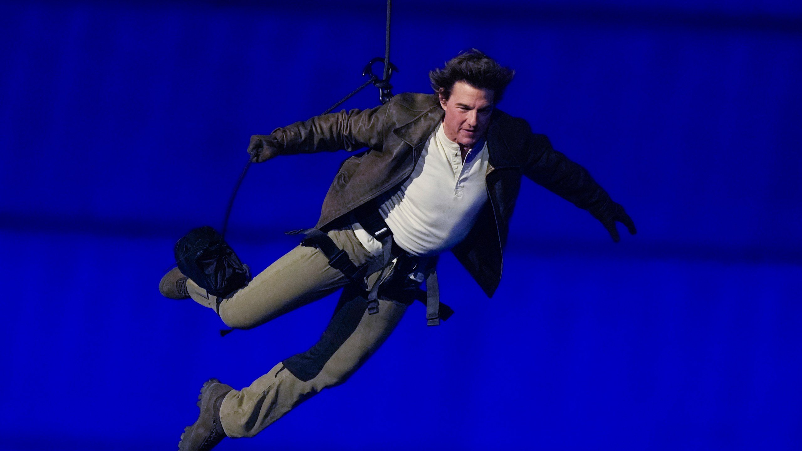 FILE - Tom Cruise is lowered on the Stade de France during the 2024 Summer Olympics closing ceremony, Aug. 11, 2024, in Saint-Denis, France. (AP Photo/Natacha Pisarenko, File)