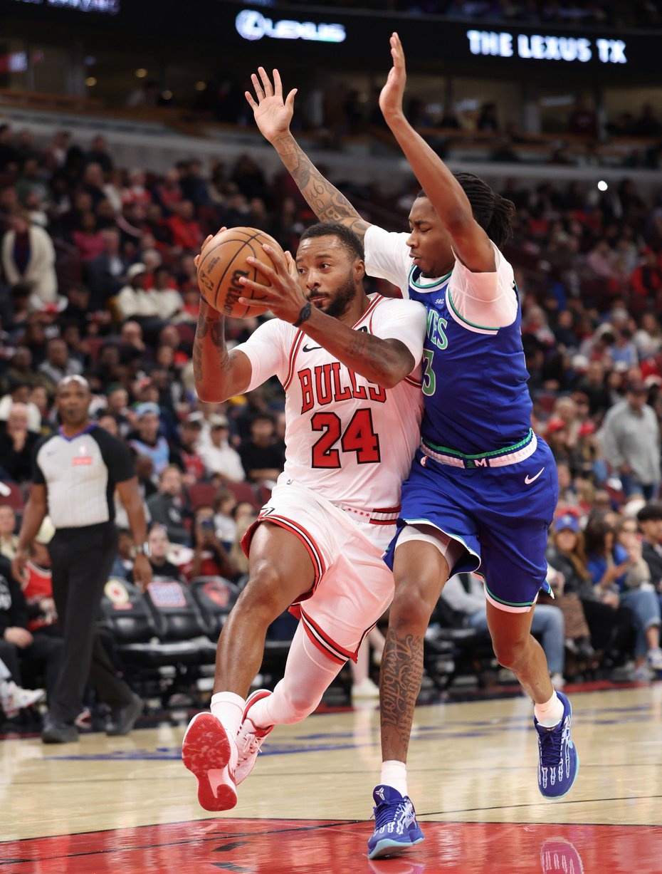 Bulls guard Norman Powell (24) drives to the basket as Timberwolves forward Isaiah Evans defends in the second quarter of a preseason game at the United Center on Oct. 16, 2026, in Chicago. (John J. Kim/Chicago Tribune)