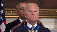 Biden receiving award from Obama