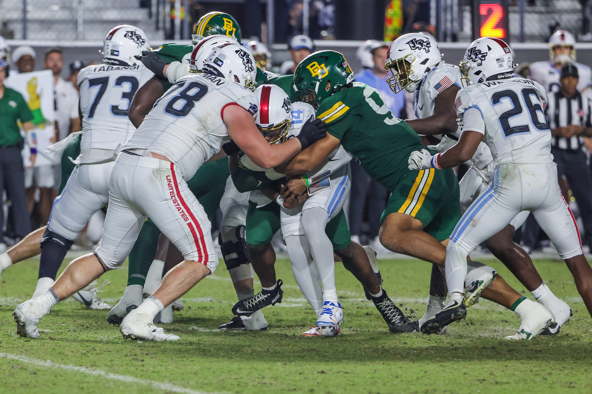 Oct 30, 2026; Orlando, Florida, USA;  Central Florida Knights quarterback Alonza Barnett III (14) is sacked by Baylor Bears defensive end Jordan Mack (97) during the second half at Acrisure Bounce House.  Mandatory Credit: Mike Watters-Imagn Images