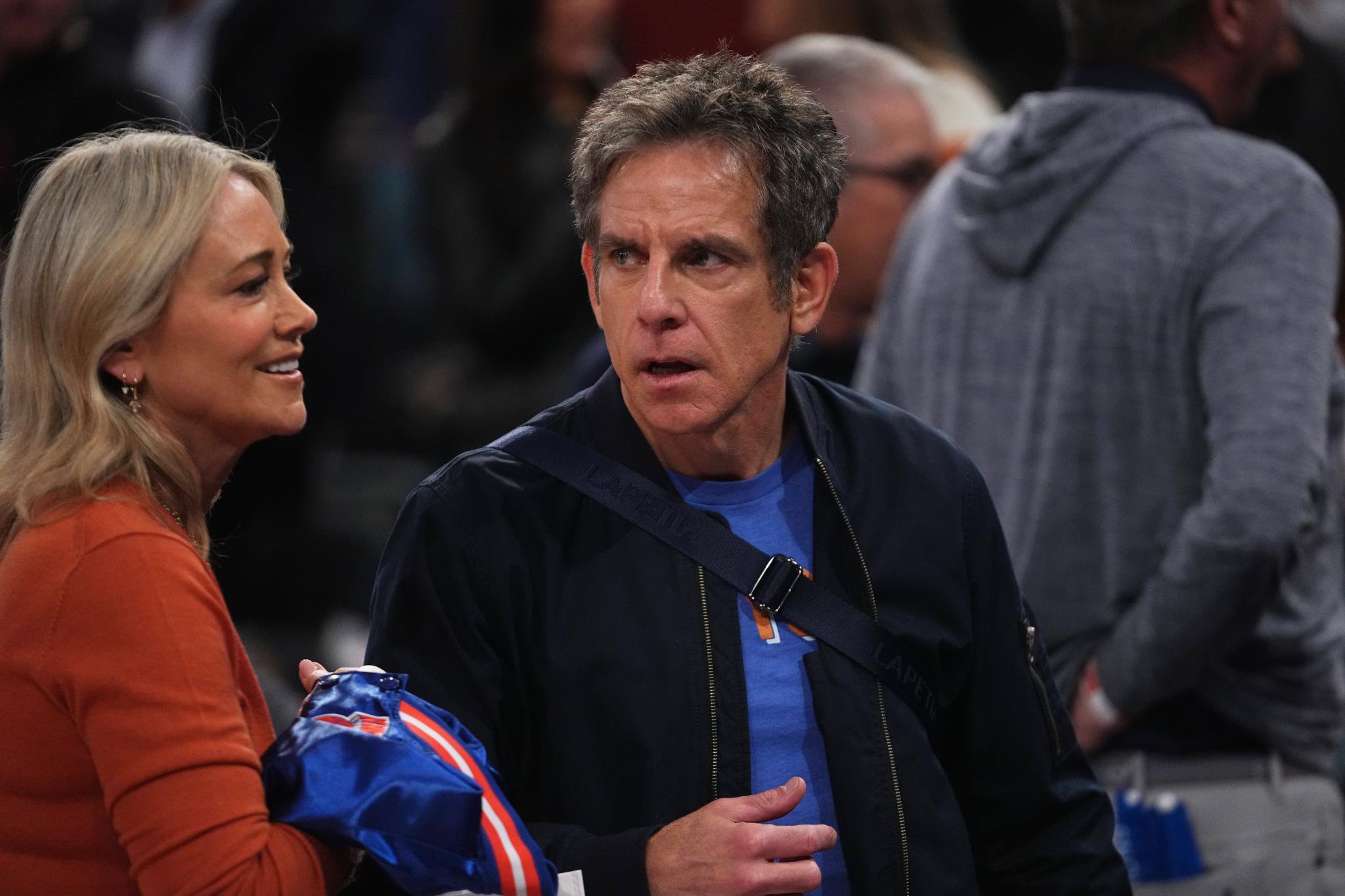 Actors Ben Stiller and Christine Taylor attend a basketball game.