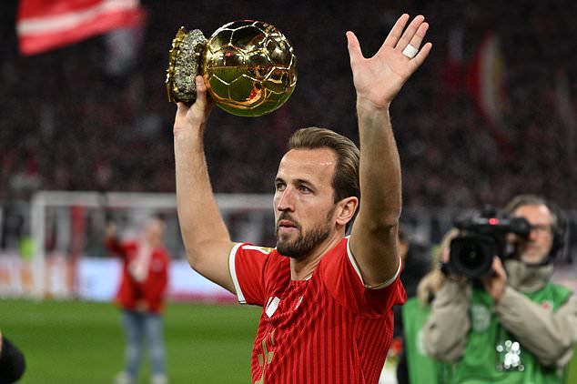 Bayern Munich's Harry Kane holds the Ballon d'Or trophy ahead of the German Bundesliga soccer match between Bayern Munich and Borussia Dortmund in Munich, Germany, Saturday, Oct. 31, 2026. (Sven Hoppe/dpa via AP)