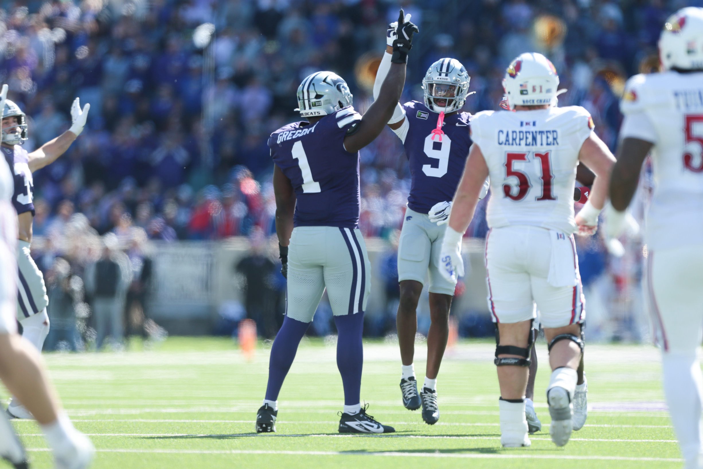 Kansas State Wildcats defensive end Wendell Gregory (1) and Kansas State Wildcats cornerback Donovan McIntosh (9) celebrate a loss of yards from Kansas Jayhawks during the Sunflower Showdown game at Bill Snyder Family Stadium in Manhattan, Kansas on Oct. 17, 2026.