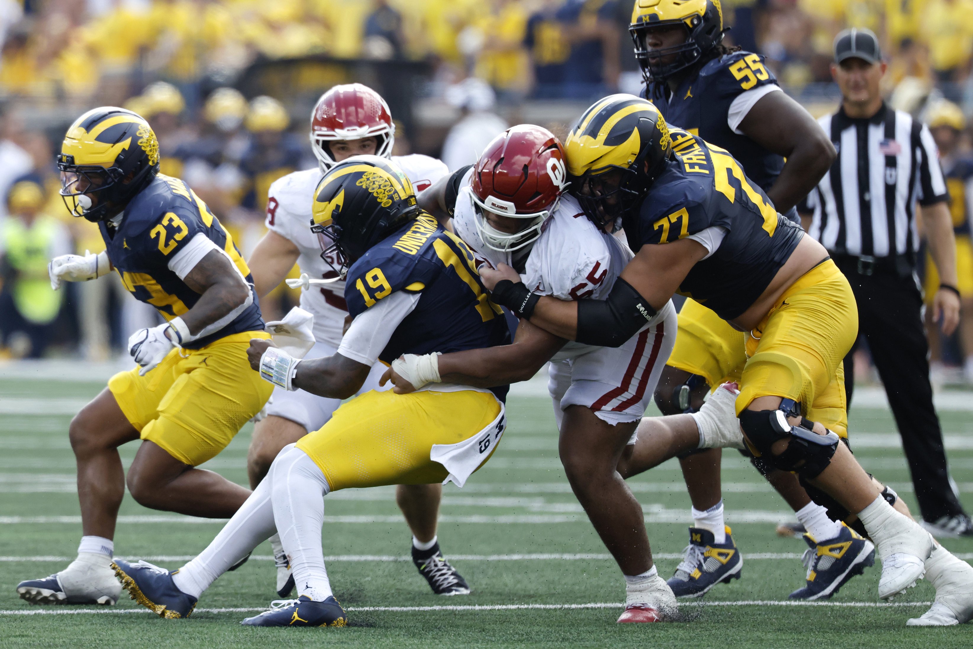 Sep 12, 2026; Ann Arbor, Michigan, USA;  Oklahoma Sooners defensive line Jayden Jackson (65) tackles Michigan Wolverines quarterback Bryce Underwood (19) during the fourth quarter at Michigan Stadium.  Mandatory Credit: Rick Osentoski-Imagn Images