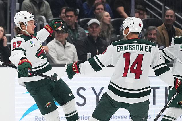 Minnesota Wild left wing Kirill Kaprizov (97) celebrates scoring against the Seattle Kraken with center Joel Eriksson Ek (14) during the first period of an NHL hockey game Saturday, Oct. 24, 2026, in Seattle. (AP Photo/Lindsey Wasson)