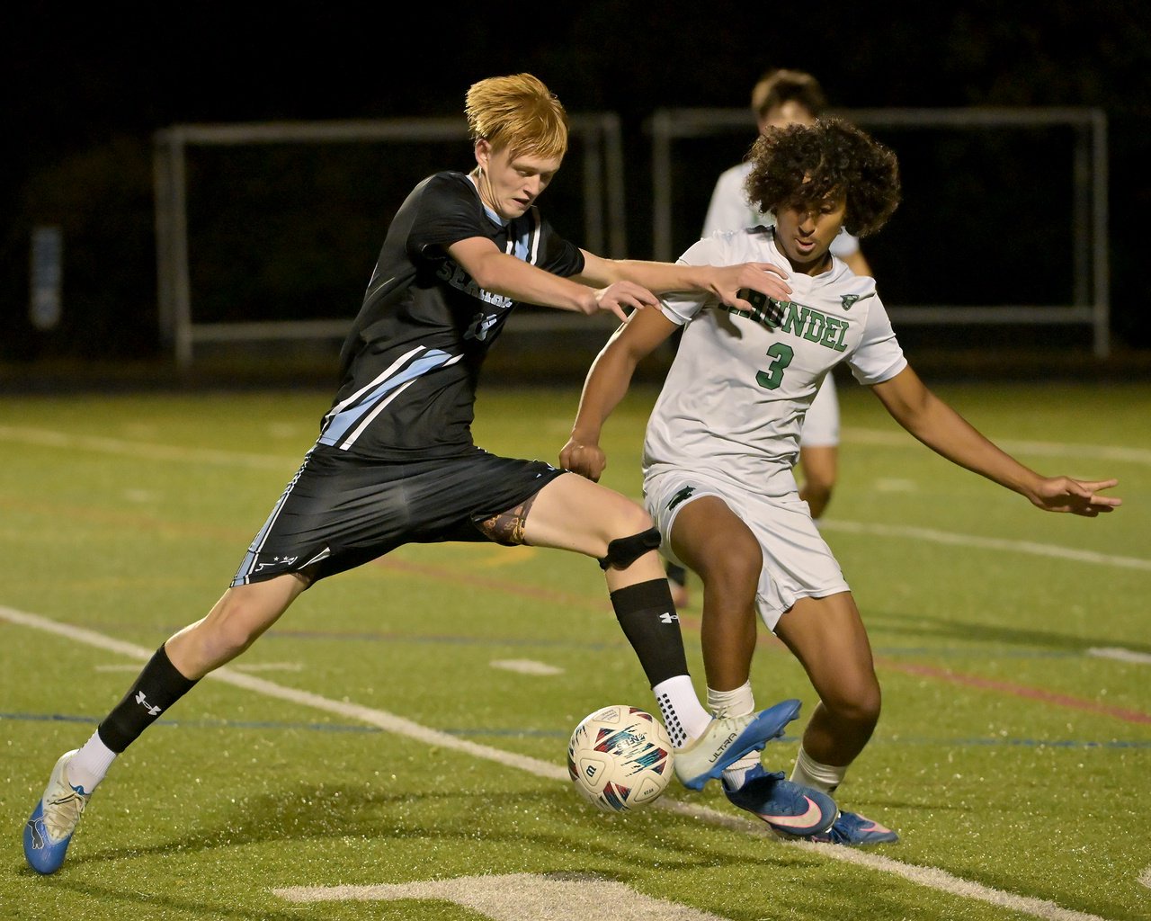South River Seahawks Gavin Curtis #18 and Arundel Wildcats Jai Killebrew #3 battle for the ball during the first half. The visiting Arundel Wildcats defeat the South River Seahawks, 2-1, in overtime in an MPSSAA Class 3A East II quarterfinal boys soccer game Wednesday evening. (Paul W. Gillespie/Staff)
