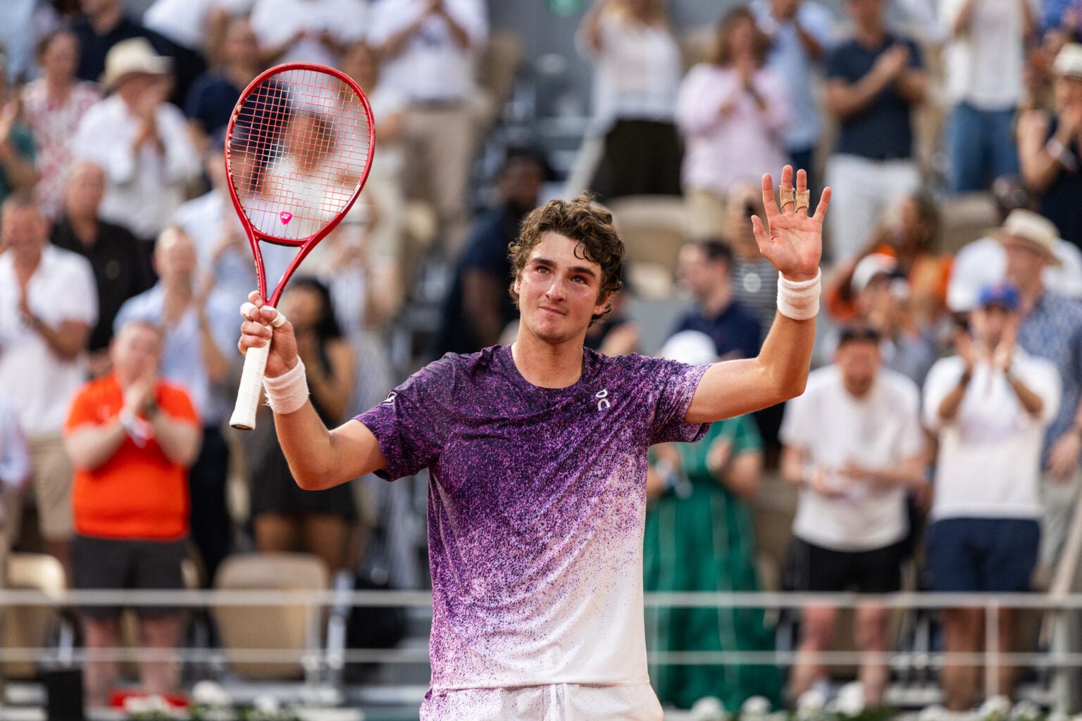 Joao Fonseca celebrates after beating Novak Djokovic at Roland Garros.