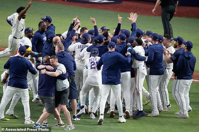 The Tampa Bay Rays celebrate their win against the Cleveland Guardians in Game 6 of an American League Championship Series baseball game in St. Petersburg, Fla. Monday, Oct. 19, 2026. (AP Photo/Chris O'Meara)