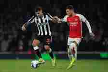 Bruno Guimaraes of Newcastle United holds off Ben White of Arsenal  during the Premier League match between Arsenal FC and Newcastle United at Emir...