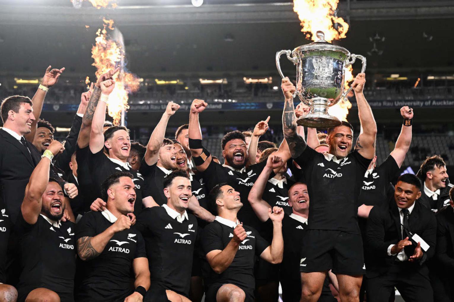 Codie Taylor hoists the Bledisloe Cup aloft for New Zealand