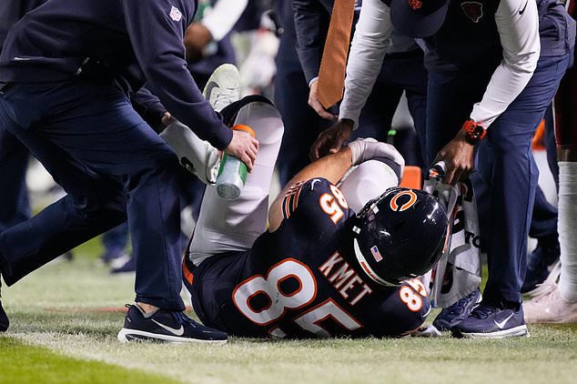 Chicago Bears tight end Cole Kmet (85) holds his right leg after suffering an injury on a pass play during the second half of an NFL football game against the New England Patriots in Chicago, Thursday, Oct. 22, 2026. (AP Photo/Nam Y. Huh)