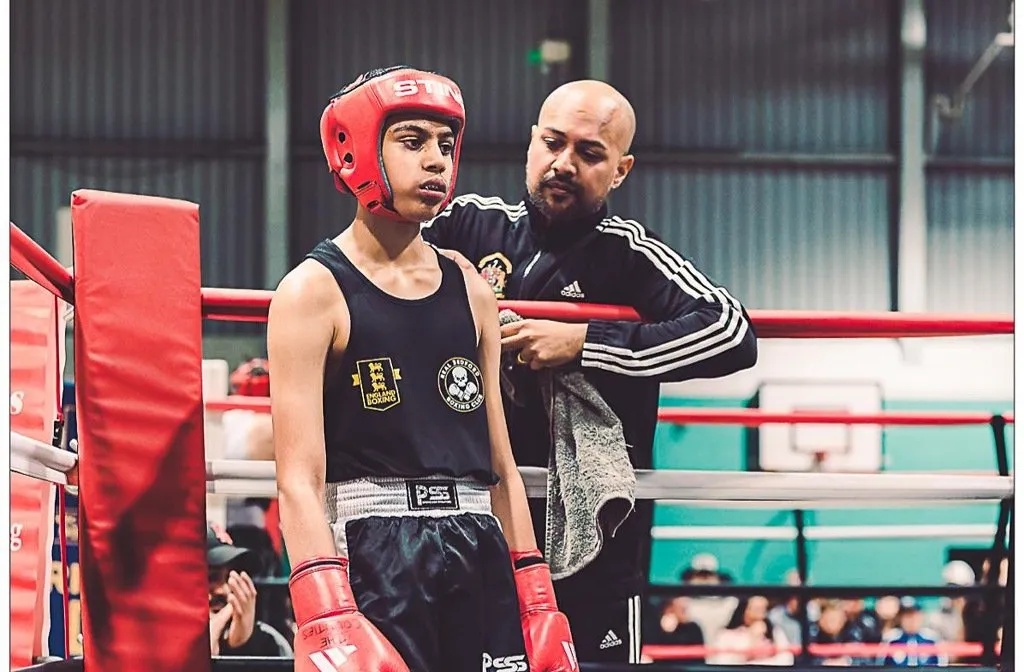 12-year old Musa Khan with his coach in the red corner ahead of a boxing bout in Aylesbury