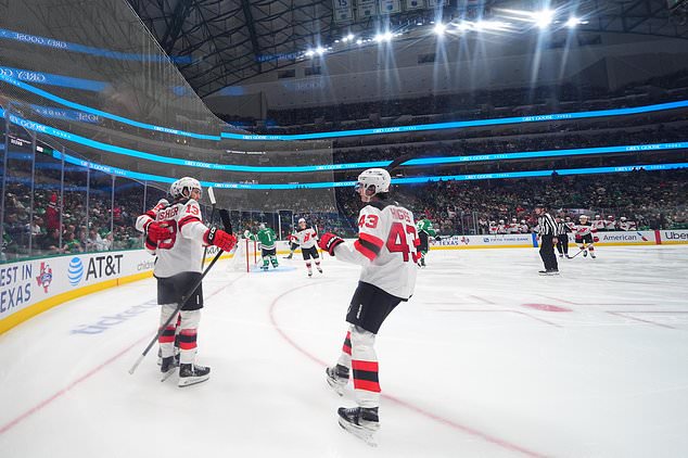 New Jersey Devils center Nico Hischier (13) celebrates his second period goal with teammates during an NHL hockey game against the Dallas Stars, Tuesday, Oct. 27, 2026, in Dallas. (AP Photo/Julio Cortez)