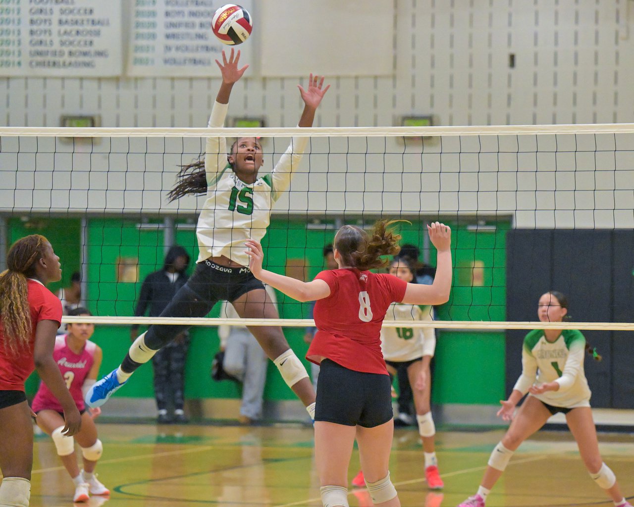 Arundel Wildcats Imani Monroe #15 leaps up to defend a Crofton ball in the first set. The Arundel Wildcats defeated the visiting Crofton Cardinals in three sets in their high school volleyball match Tuesday evening. (Paul W. Gillespie/Staff)