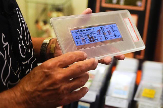 Baltimore Orioles fan Rick Taylor holds a ticket from the first baseball game of Cal Ripken Jr.'s 2,632 game "Iron Man" streak, at his home in Reisterstown, Md., Tuesday, Oct. 13, 2026. (AP Photo/Stephanie Scarbrough)