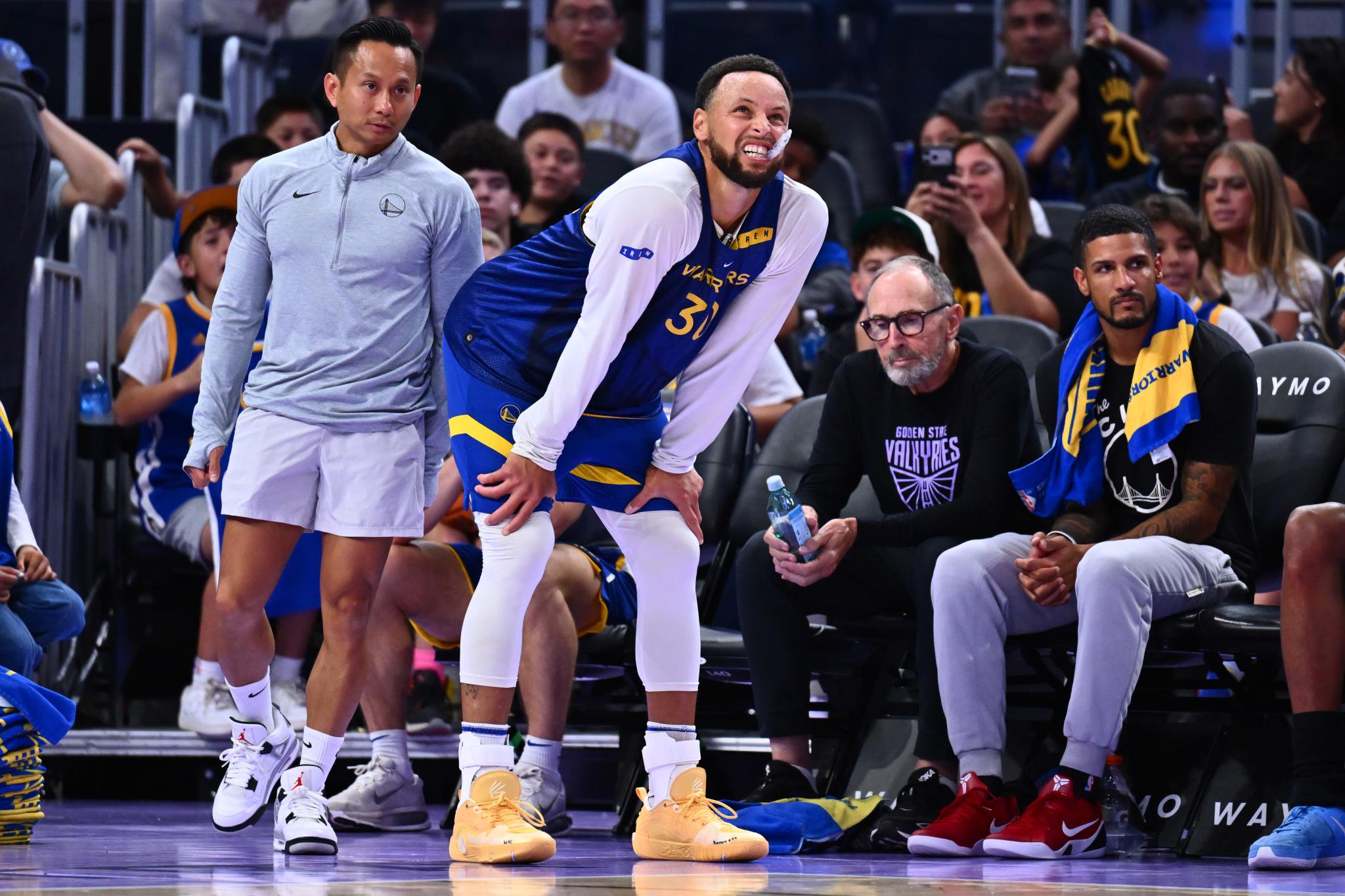 Golden State Warriors' Stephen Curry reacts after injuring himself during an open practice.