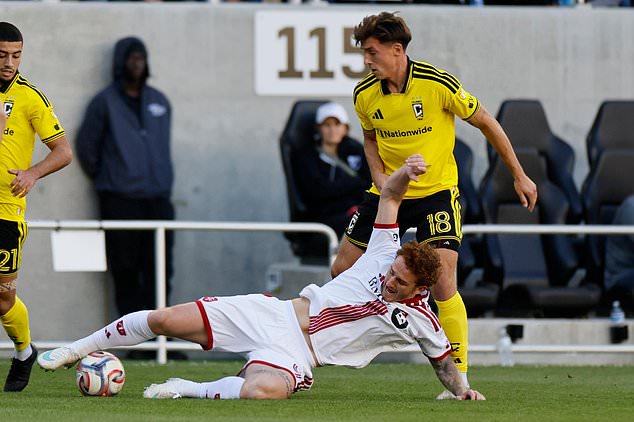 Toronto FC's Josh Sargent, left, kicks the ball away from Columbus Crew's Malte Amundsen during the first half of an MLS soccer match, Saturday, Oct. 24, 2026, in Columbus, Ohio. (AP Photo/Jay LaPrete)