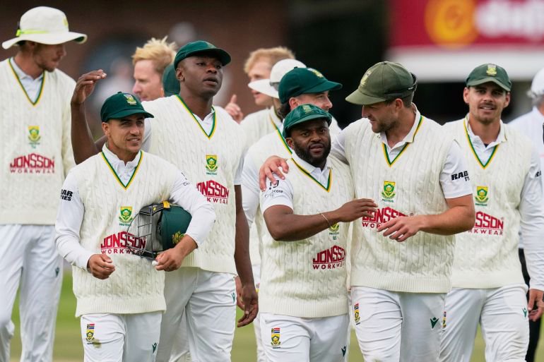 South Africa's captain Temba Bavuma, center right, celebrates with teammates after winning the second cricket test match between South Africa and Australia