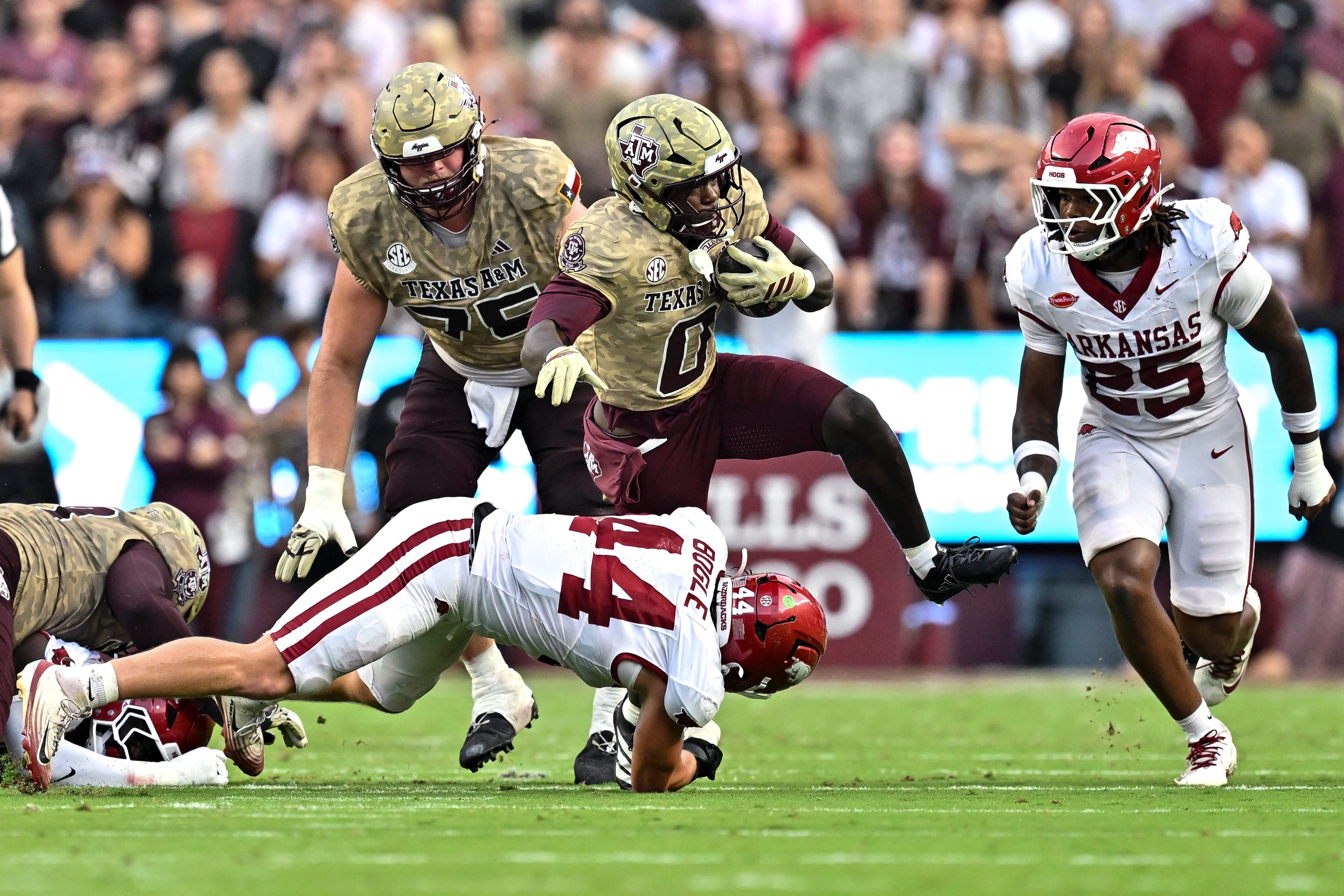 Oct 3, 2026; College Station, Texas, USA; Texas A&amp;M Aggies running back KJ Edwards (0) runs the ball as Arkansas Razorbacks linebacker Ben Bogle (44) attempts a tackle during the first half at Kyle Field. Mandatory Credit: Maria Lysaker-Imagn Images