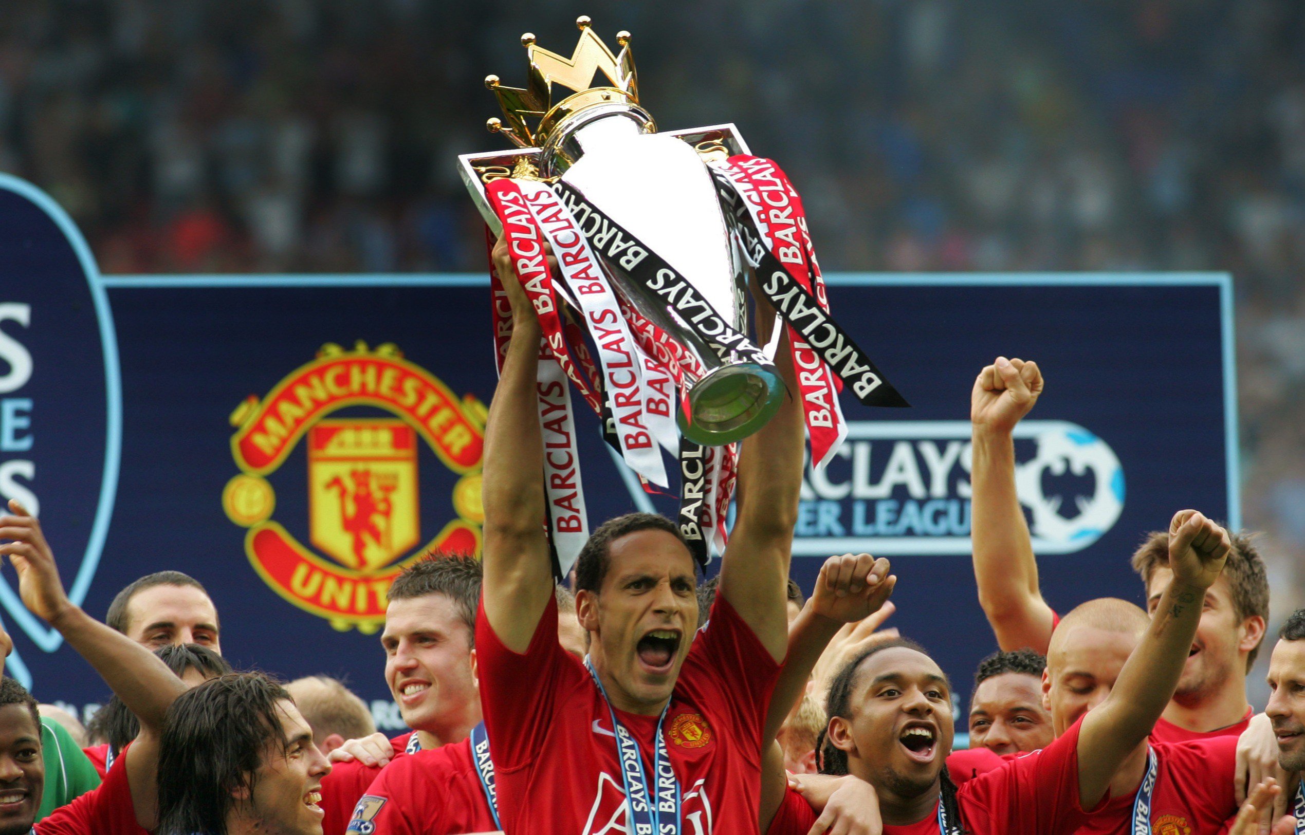 Rio Ferdinand lifts the Premier League trophy while playing for Manchester United