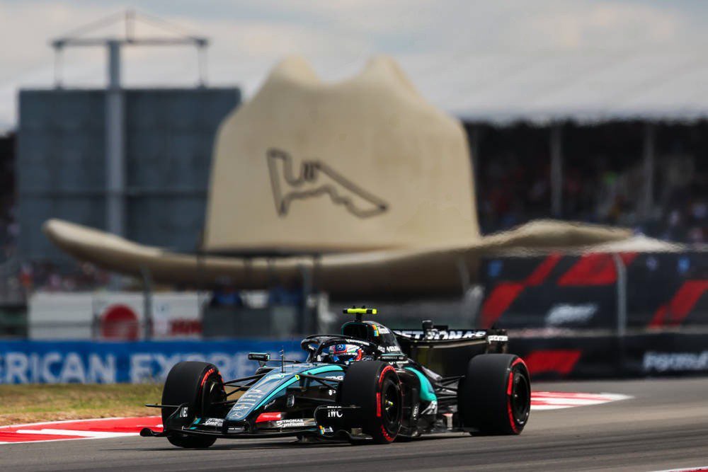 Kimi Antonelli in his Mercedes Formula 1 car at the 2026 United States Grand Prix in Austin, with a large cowboy hat sculpture behind.
