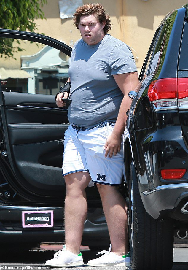 Christopher - seen in August 2018 - lost 250 pounds over the course of five years by changing his diet and focusing on a consistent exercise regimen, including weight lifting, boxing and hiking