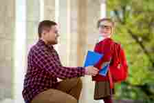 Dad Helping Daughter on First Day at School