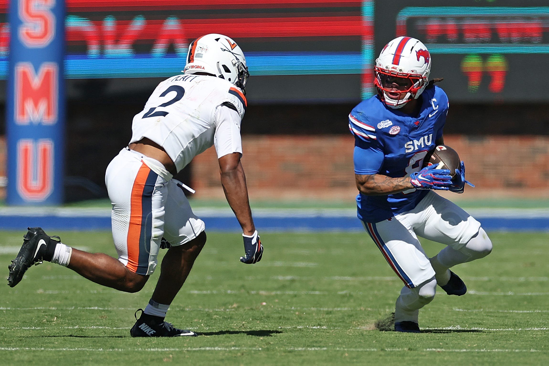 Yamir Knight of the SMU Mustangs is brought down by Donavon Platt of the Virginia Cavaliers during the second half at Gerald J. Ford Stadium on October 17, 2026 in Dallas, Texas.