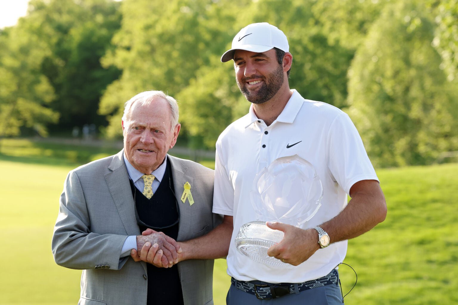 Jack Nicklaus and Scottie Scheffler pose for photos with the trophy at the Memorial Tournament at Muirfield Village