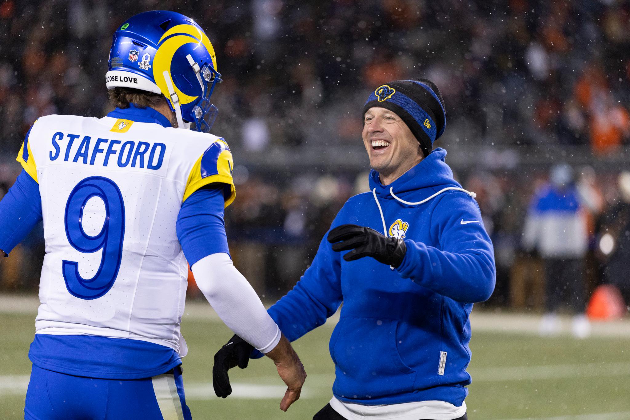 Los Angeles Rams quarterback Matthew Stafford greets a coach on the field during the NFC Divisional Playoffs.